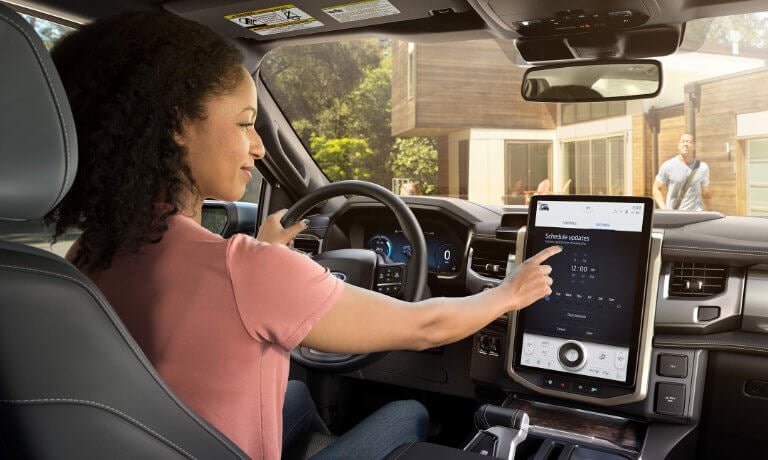 2022 Ford F-150 Lightning interior woman interacting with infotainment system